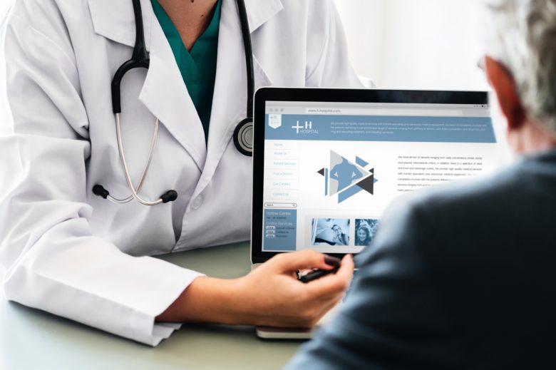 doctor showing a computer to a patient during Medical Business Sales in For Lauderdale 